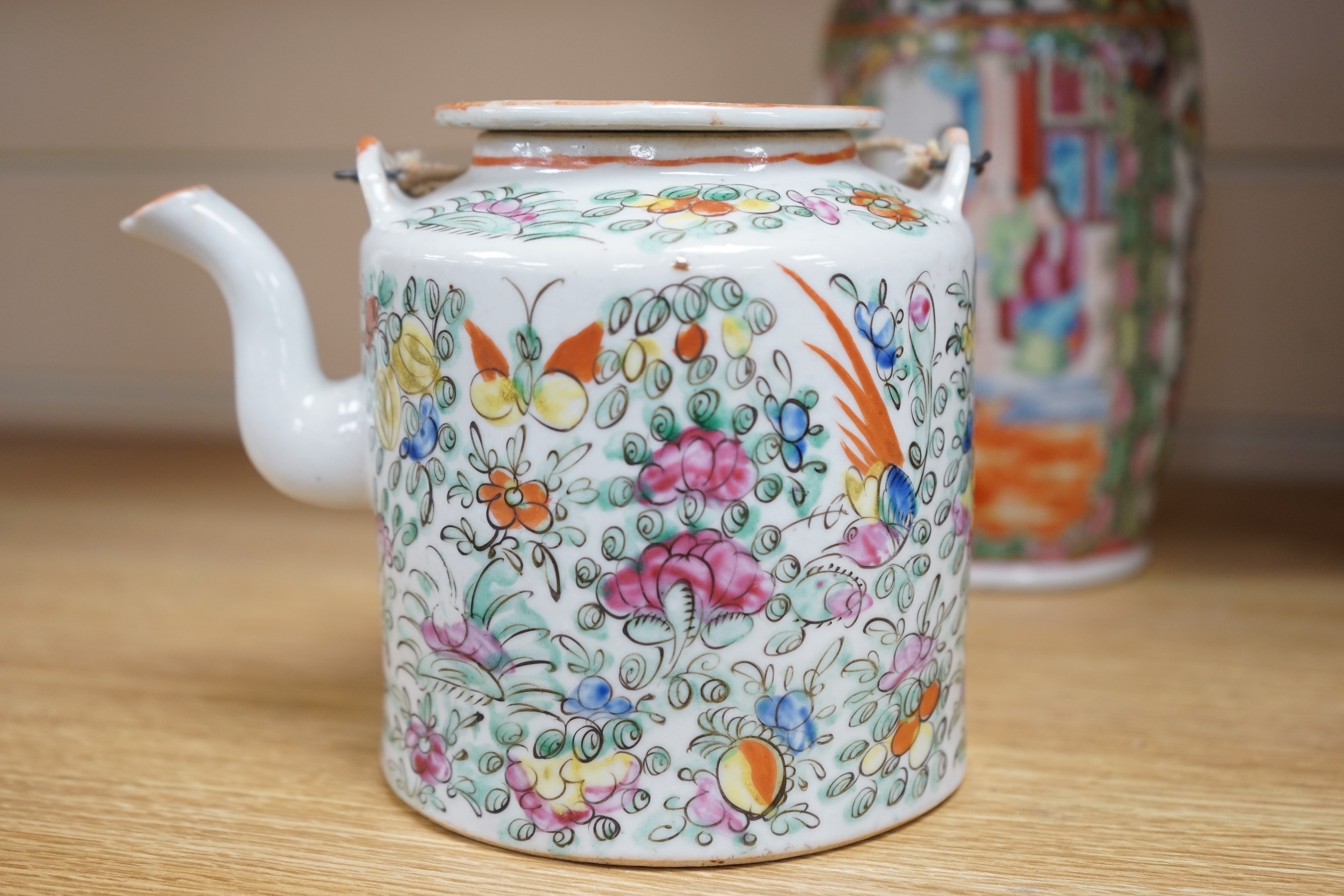 Three Chinese famille rose vases and a teapot, late 19th/early 20th century, tallest vase 29.5 cms high